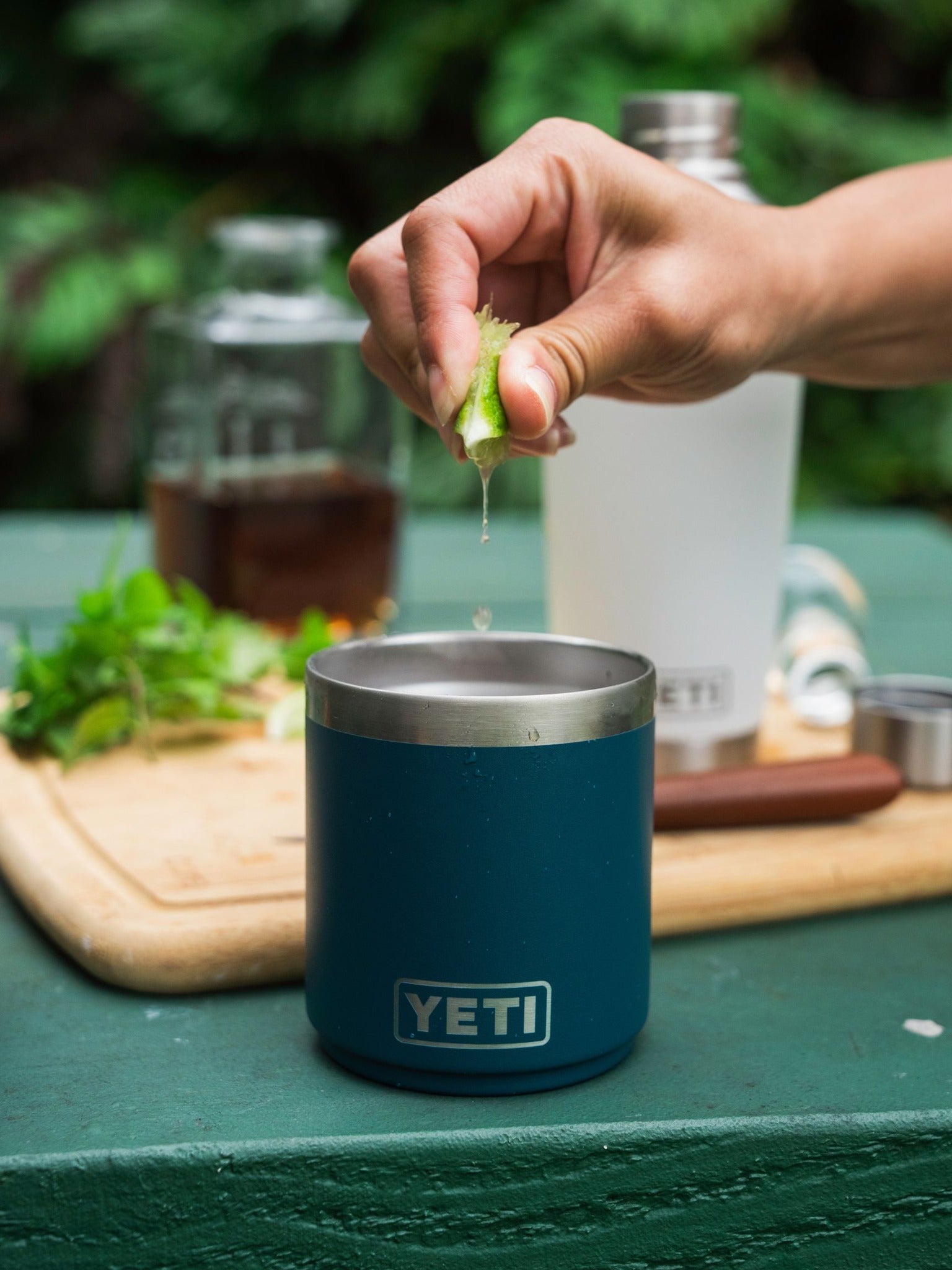 Squeezing lime into Yeti lowball cocktail