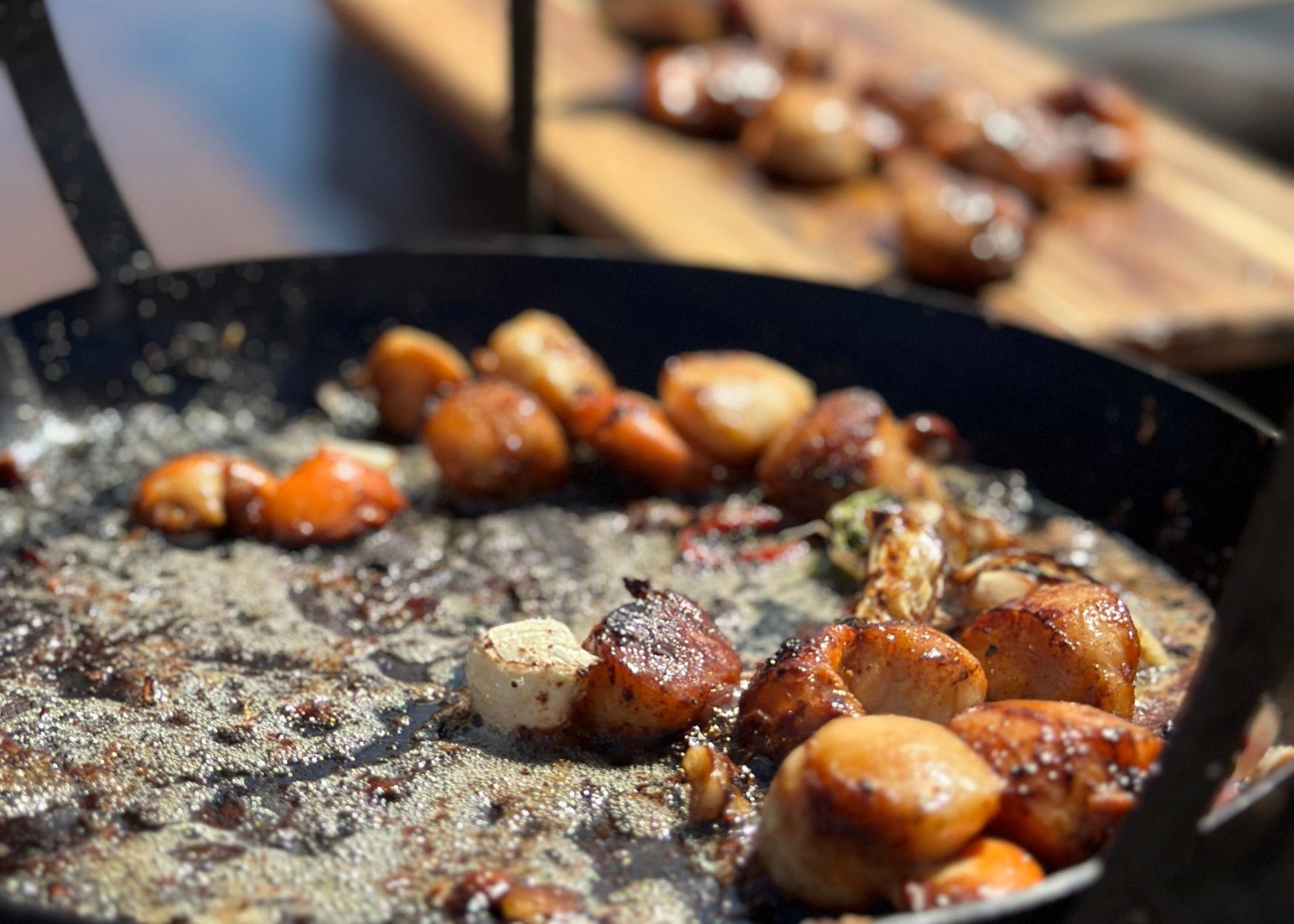 Scallops cooked on Kadai bowl on beach
